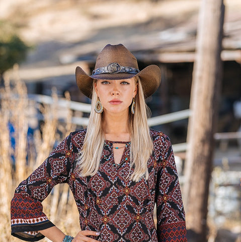 Model wearing ladies cowboy hat with horse buckle
