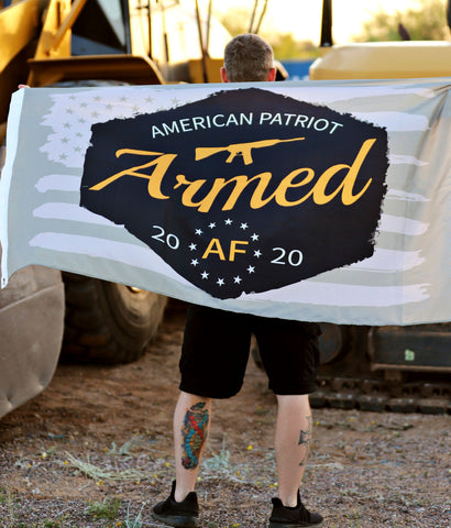 Armed AF™ logo flag being held by patriot