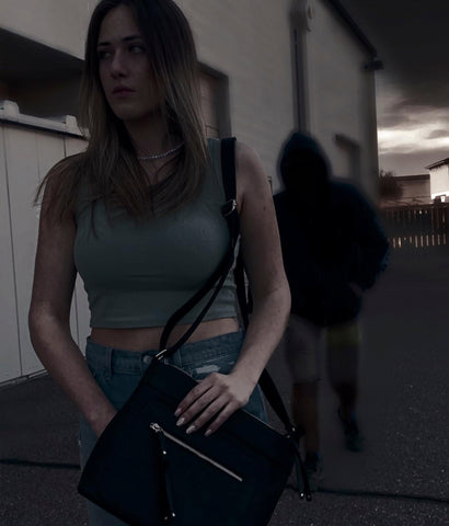 model with conceal carry bag in parking lot with bad man