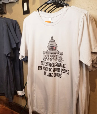 Stupid People in large groups t shirt on display in gift shop