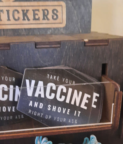 Take Your Vaccine and shove it up your ass sticker in store display